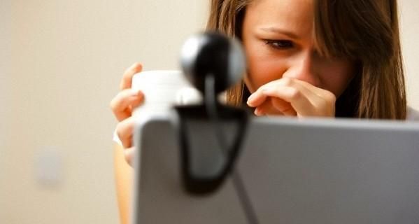 UK --- Close up of a woman using laptop computer with web cam --- Image by © Julian Winslow/ableimages/Corbis